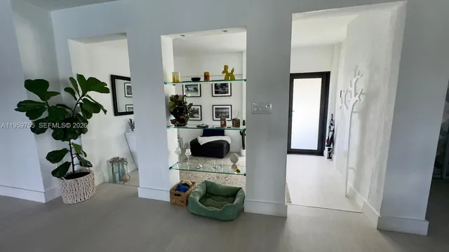 a view of living room with furniture and a potted plant
