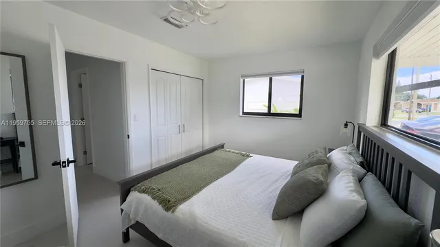 a bedroom with a bed and window