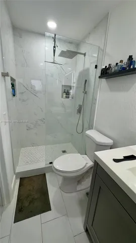 a bathroom with a toilet and a shower
