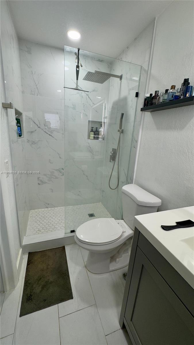 6705 Ficus Drive Miramar, FL 33023 - Photo 23 of 37 a bathroom with a toilet and a shower