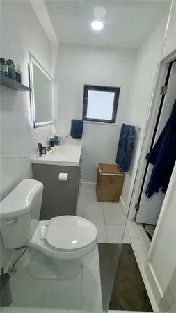 a white toilet sitting next to a bathroom sink