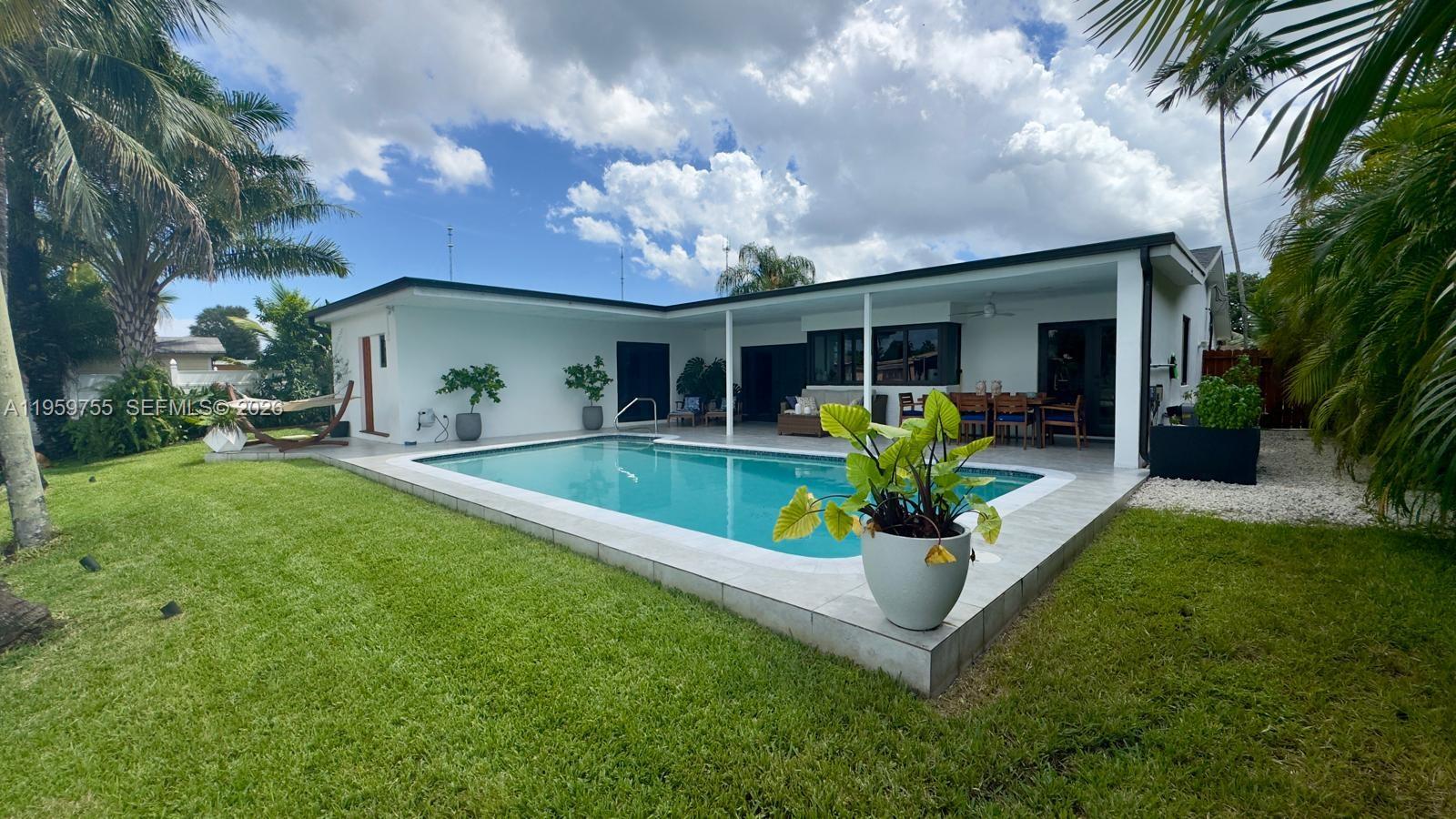 6705 Ficus Drive Miramar, FL 33023 - Photo 25 of 37 a view of a house with swimming pool and porch with furniture