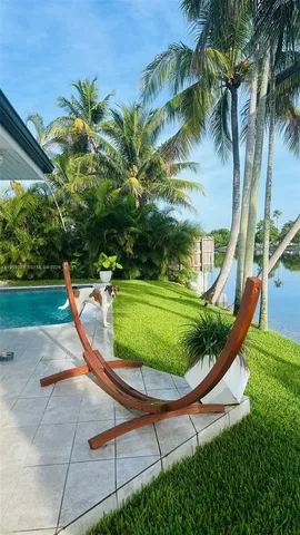 a swimming pool with outdoor seating and entertaining space