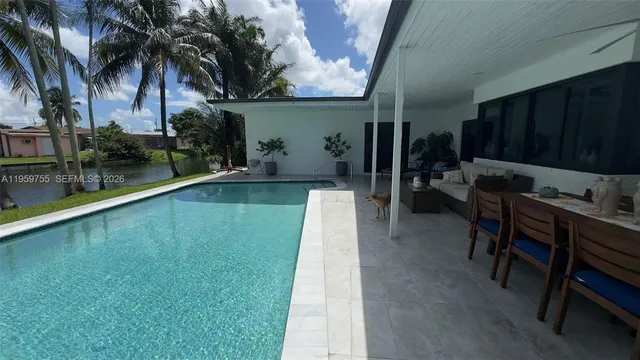 a swimming pool with outdoor seating and yard