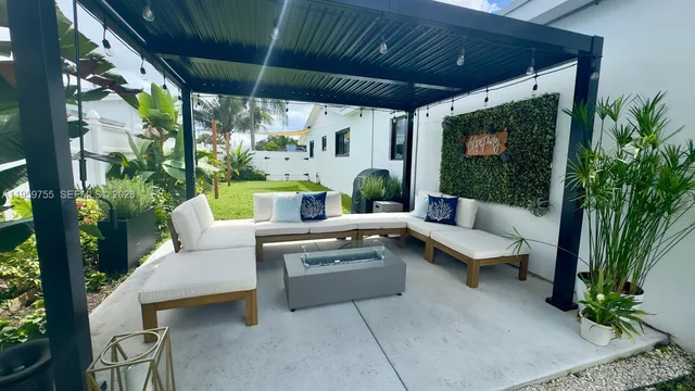 a outdoor space with patio couch and potted plants