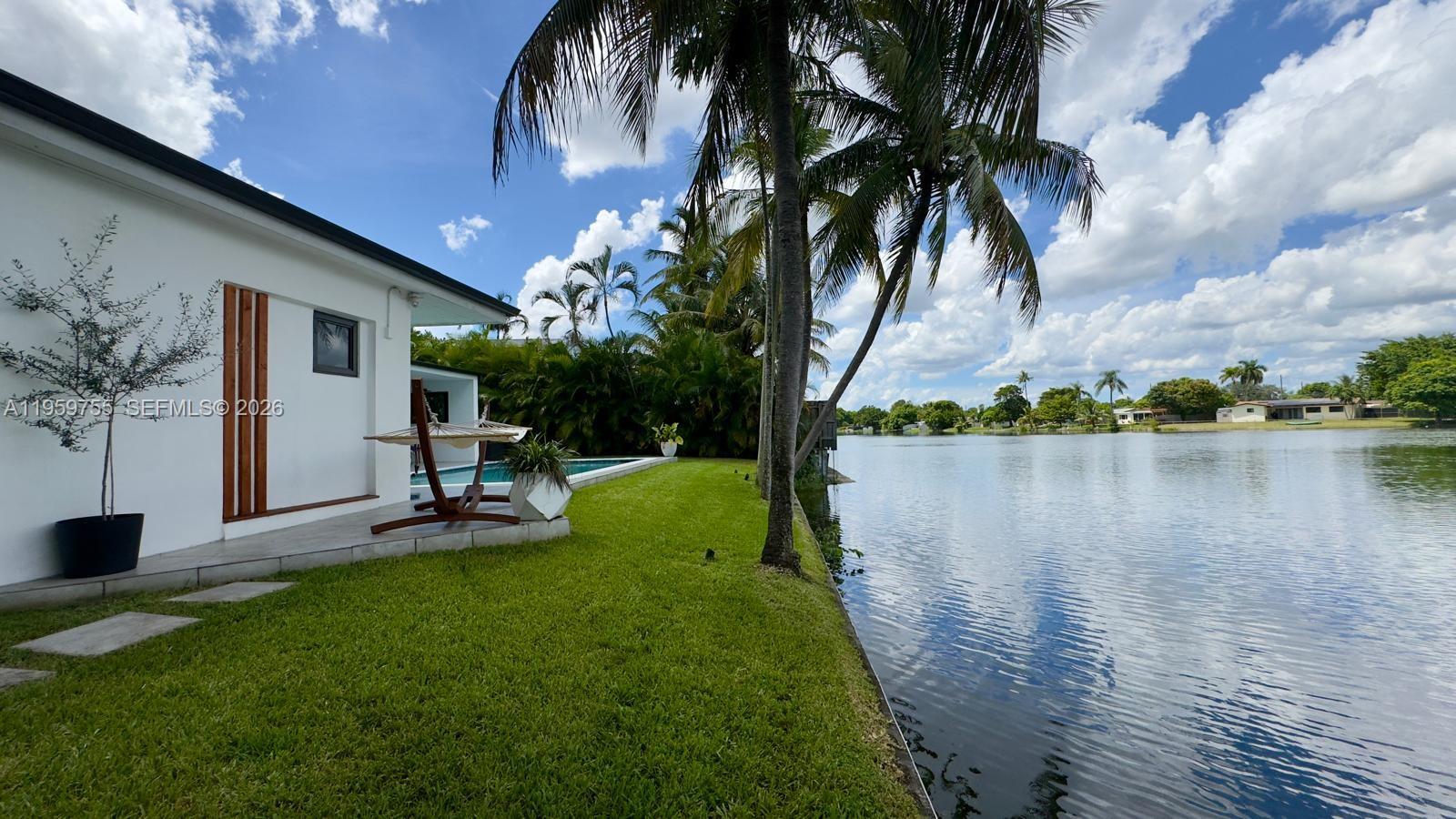 6705 Ficus Drive Miramar, FL 33023 - Photo 32 of 37 a view of a backyard with a sitting area and a lake view