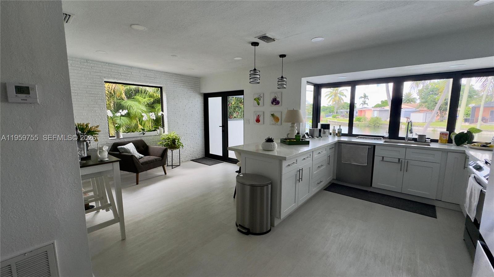 6705 Ficus Drive Miramar, FL 33023 - Photo 7 of 37 a large white open kitchen with a large window