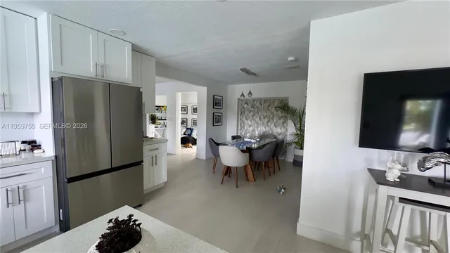 a kitchen with stainless steel appliances a refrigerator and a sink