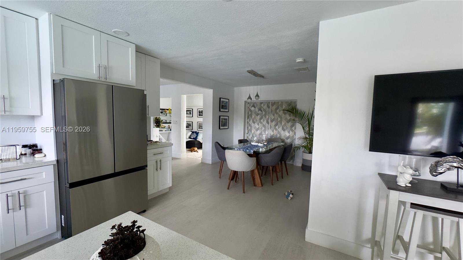 6705 Ficus Drive Miramar, FL 33023 - Photo 8 of 37 a kitchen with stainless steel appliances a refrigerator and a sink