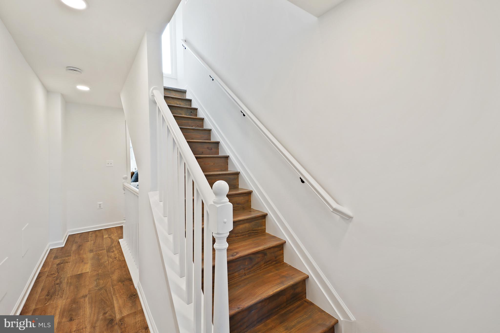 3731 Falls Road Baltimore, MD 21211 - Photo 19 of 30 a view of staircase with wooden floor and white walls