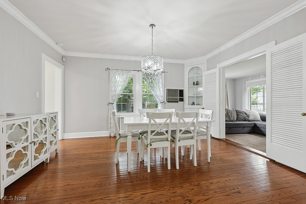 3266 Avalon Road Cleveland, OH 44120 - Photo 18 of 46 Dining area with ornamental molding, hardwood / wood-style flooring, and a chandelier