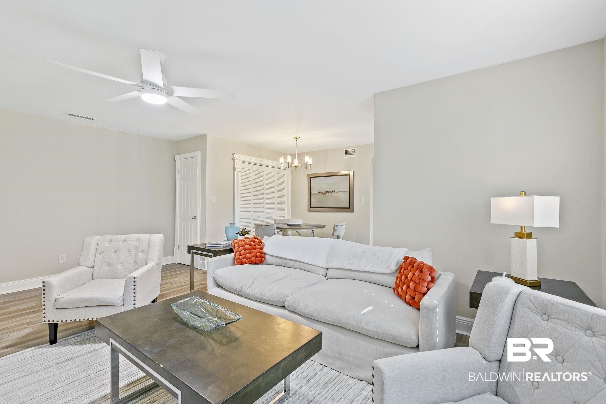 110 5th Street, Unit C103 Daphne, AL 36526 - Photo 10 of 46 Living room with ceiling fan with notable chandelier and light hardwood / wood-style floors