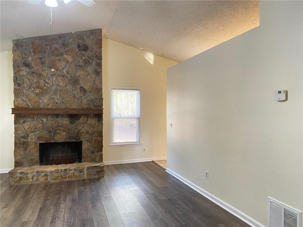 5458 Terrace Garden Way, Unit A Norcross, GA 30071 - Photo 11 of 27 a view of empty room with wooden floor and fireplace