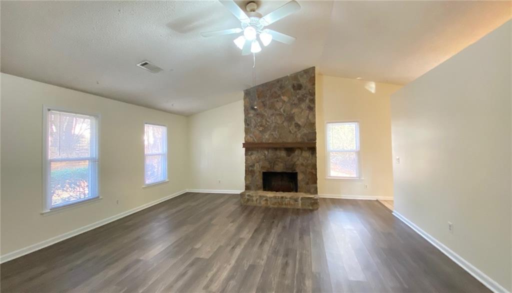 5458 Terrace Garden Way, Unit A Norcross, GA 30071 - Photo 13 of 27 a view of an empty room with window and wooden floor
