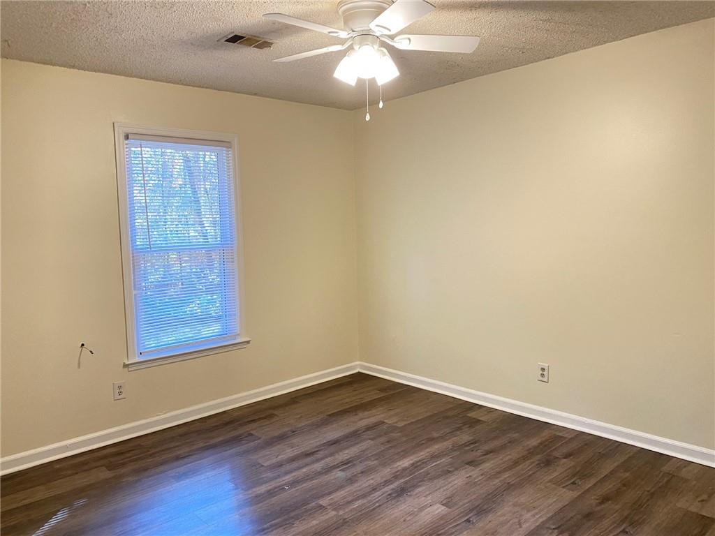 5458 Terrace Garden Way, Unit A Norcross, GA 30071 - Photo 15 of 27 an empty room with wooden floor and windows