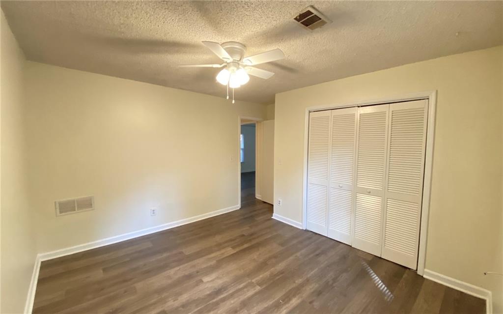 5458 Terrace Garden Way, Unit A Norcross, GA 30071 - Photo 17 of 27 a view of an empty room with wooden floor and a window