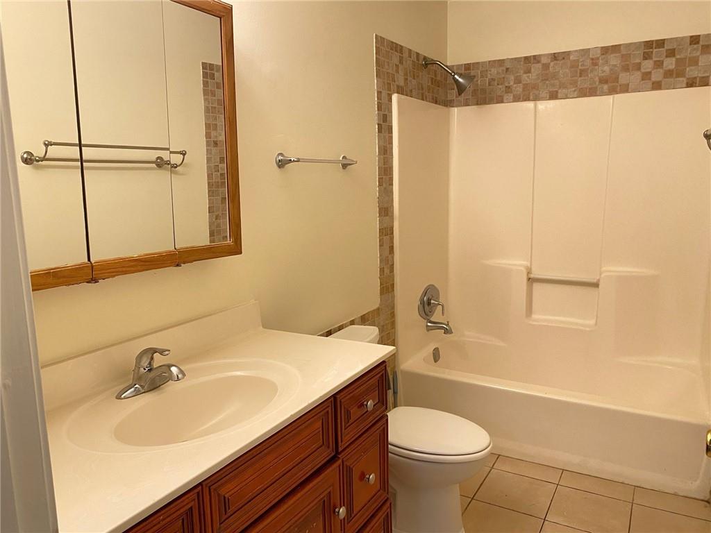 5458 Terrace Garden Way, Unit A Norcross, GA 30071 - Photo 18 of 27 a bathroom with a sink toilet and shower