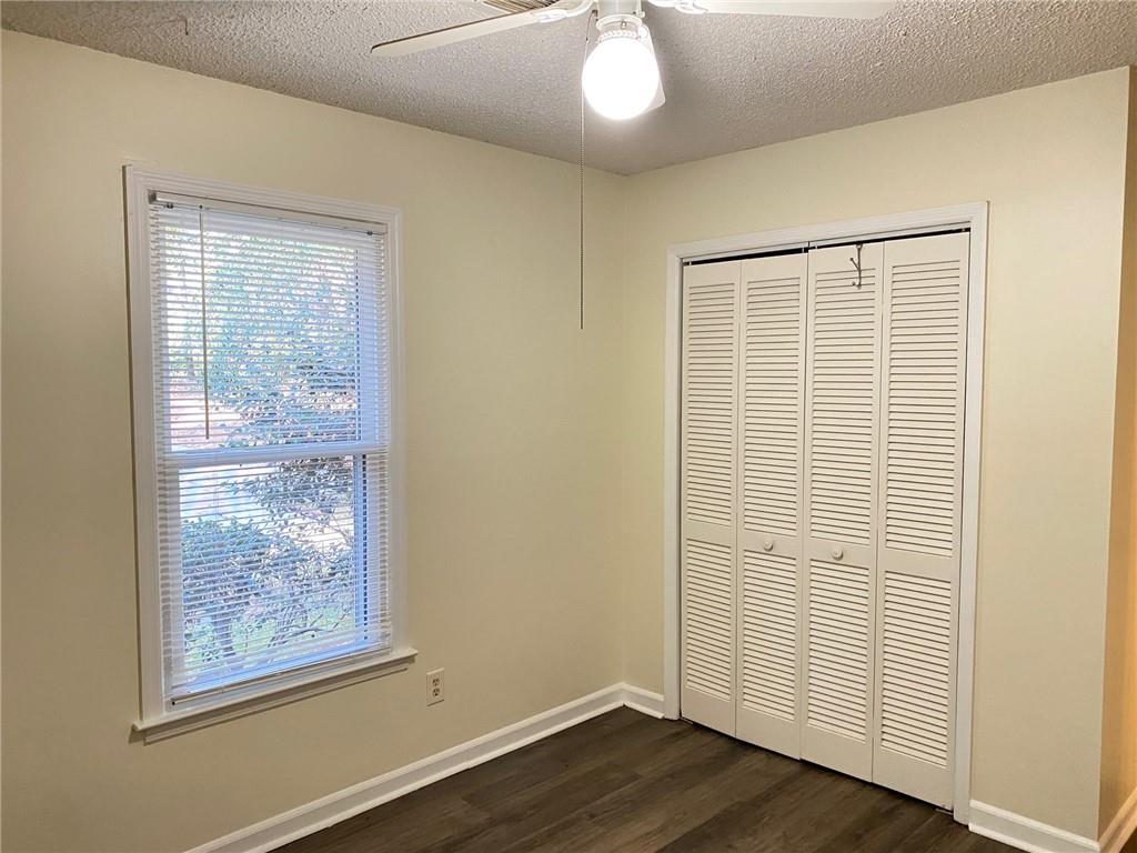 5458 Terrace Garden Way, Unit A Norcross, GA 30071 - Photo 21 of 27 a view of an empty room with wooden floor and a window