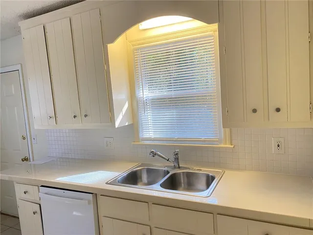 a kitchen with a sink a stove and a refrigerator