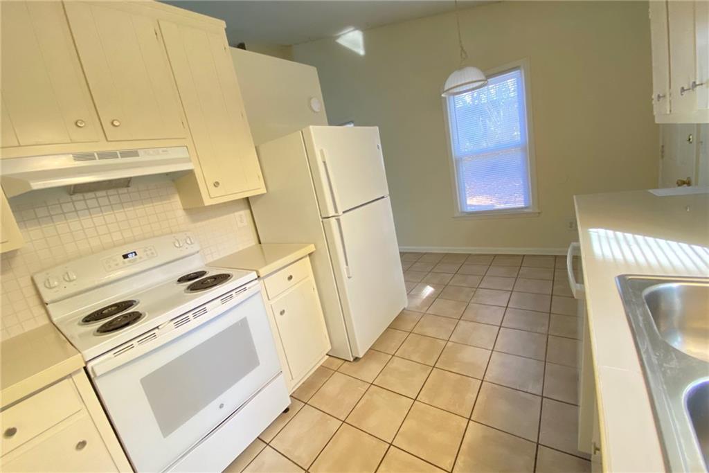 5458 Terrace Garden Way, Unit A Norcross, GA 30071 - Photo 9 of 27 a kitchen with a sink a stove and a refrigerator