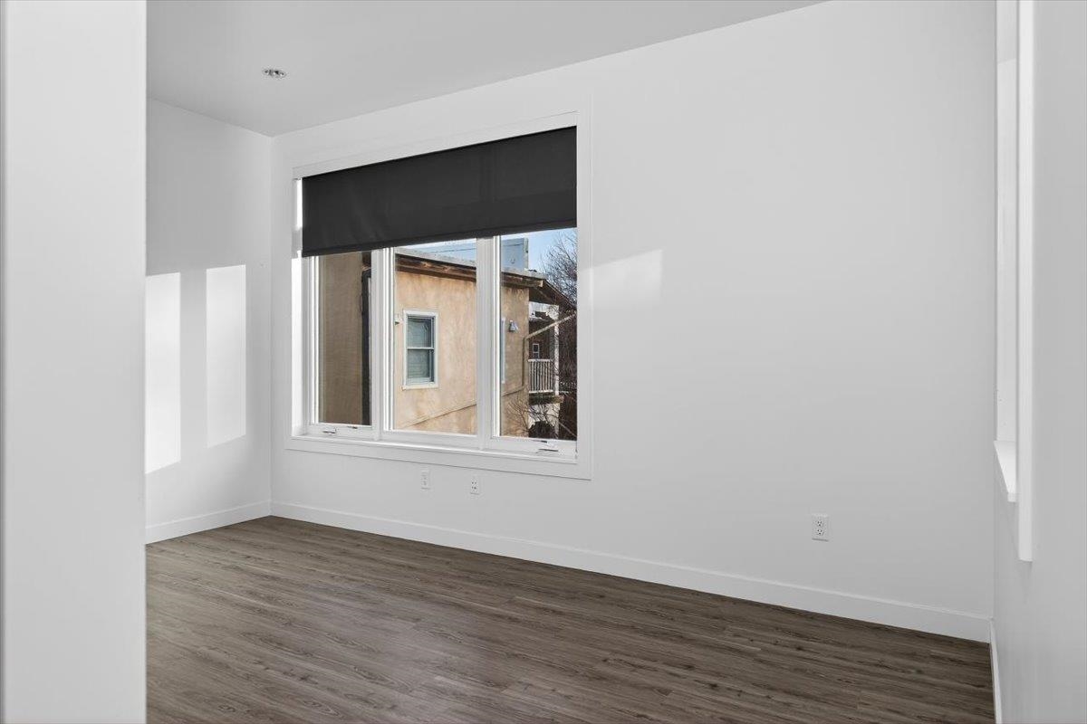 185 North Lena Street, Unit CONDO D Ridgway, CO 81432 - Photo 12 of 17 a view of an empty room with wooden floor and a window