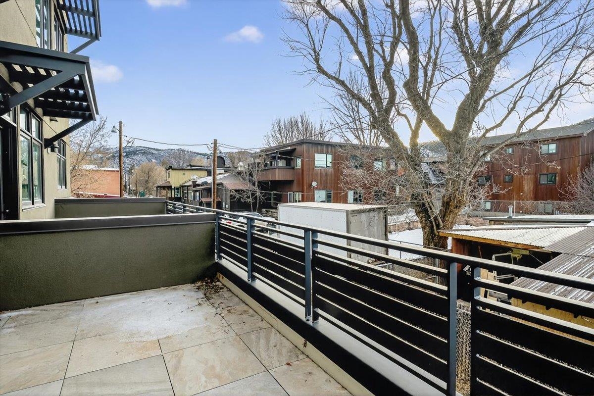 185 North Lena Street, Unit CONDO D Ridgway, CO 81432 - Photo 17 of 17 a view of a balcony with two chairs and a stove