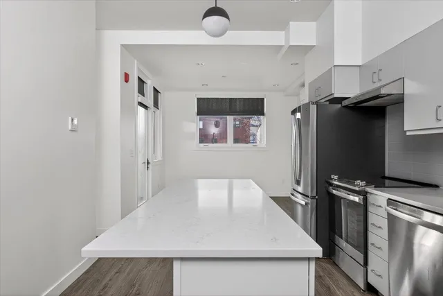 a kitchen with a refrigerator and a sink