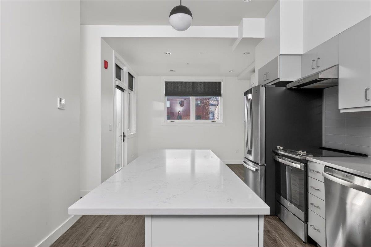 185 North Lena Street, Unit CONDO D Ridgway, CO 81432 - Photo 3 of 17 a kitchen with a refrigerator and a sink