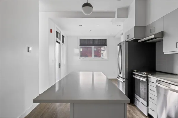 a view of a kitchen with a sink and cabinet
