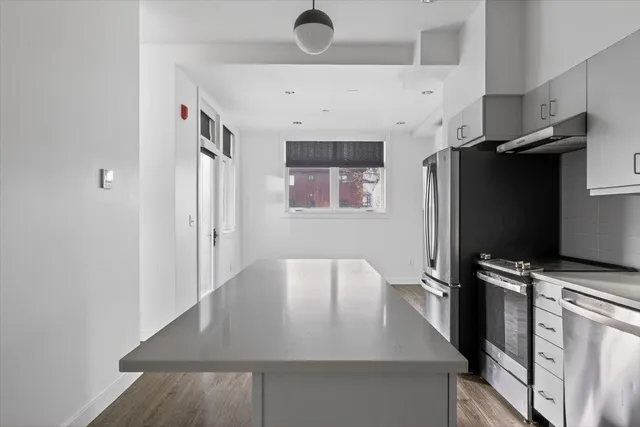 a view of a kitchen with a sink and cabinet