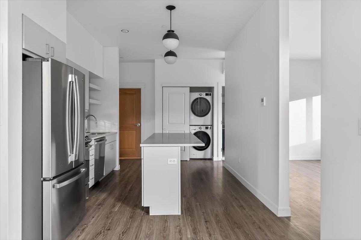 185 North Lena Street, Unit CONDO D Ridgway, CO 81432 - Photo 8 of 17 a view of a kitchen with a refrigerator and wooden floor