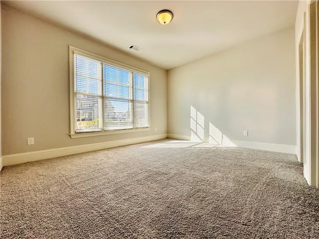 a view of a small space with wooden floor and a window