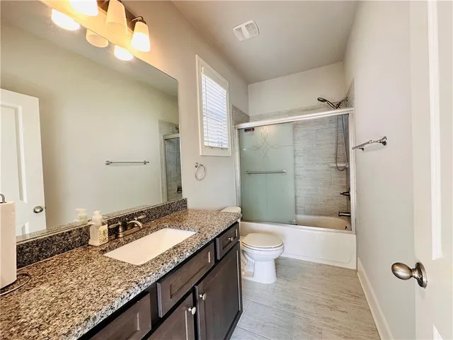 a view of a kitchen with granite countertop cabinets and a wooden floor