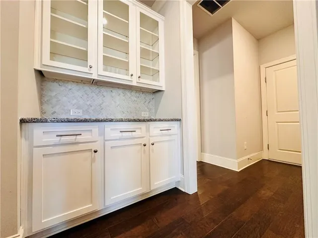 a view of a living room with hardwood floor and a large window