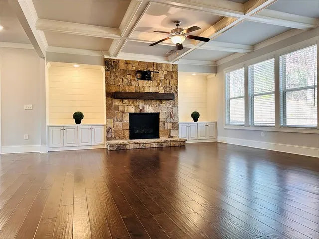 a kitchen with granite countertop white cabinets and stainless steel appliances