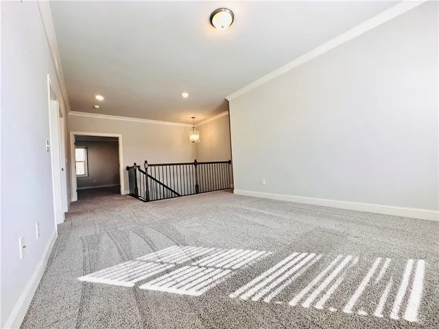 an empty room with an entryway and wooden floor