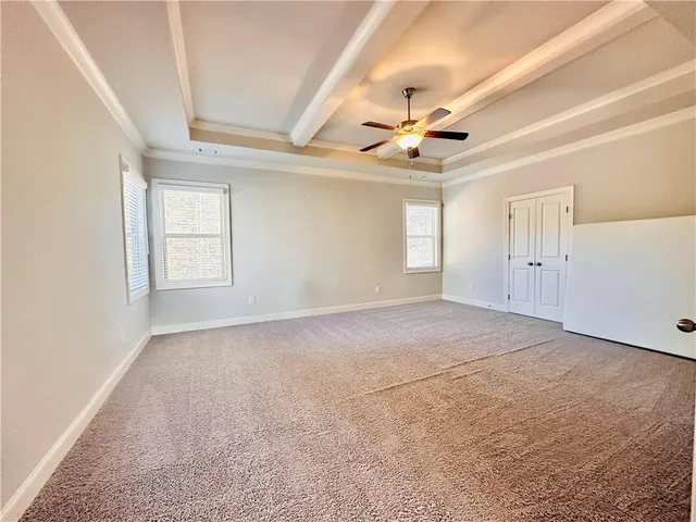 a view of an empty room and a window