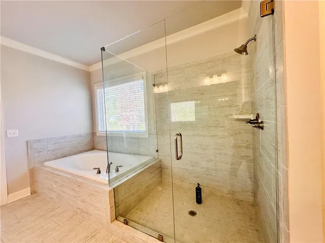 a view of an empty room with a fireplace and a window