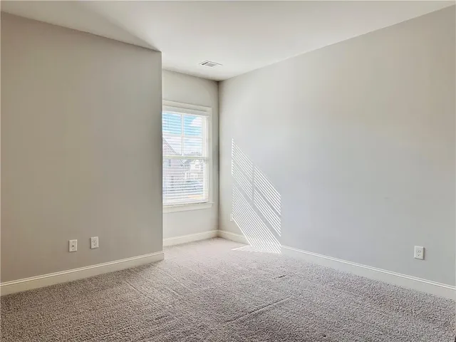a front view of a house with a yard covered in snow