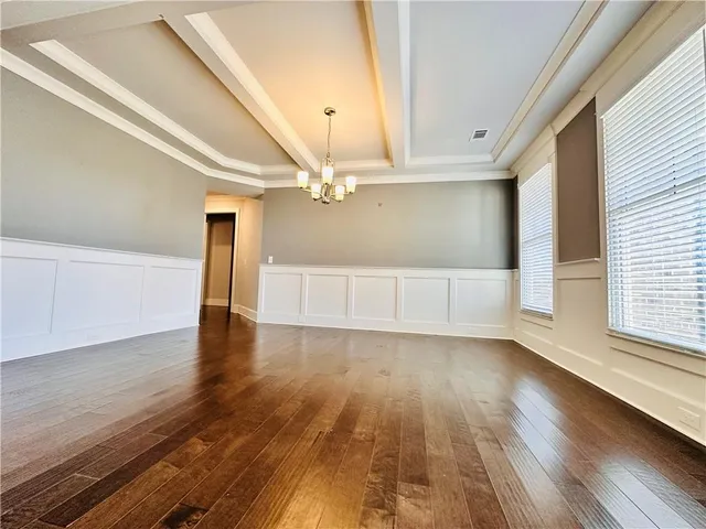 a view of a room with wooden floor and windows