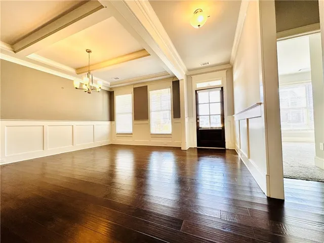 an empty room with a exposed radiator and window