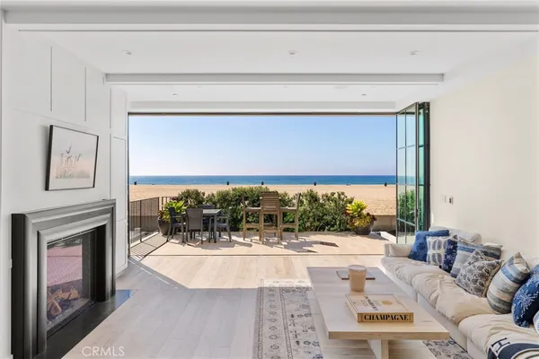 a living room with a large window and a fireplace