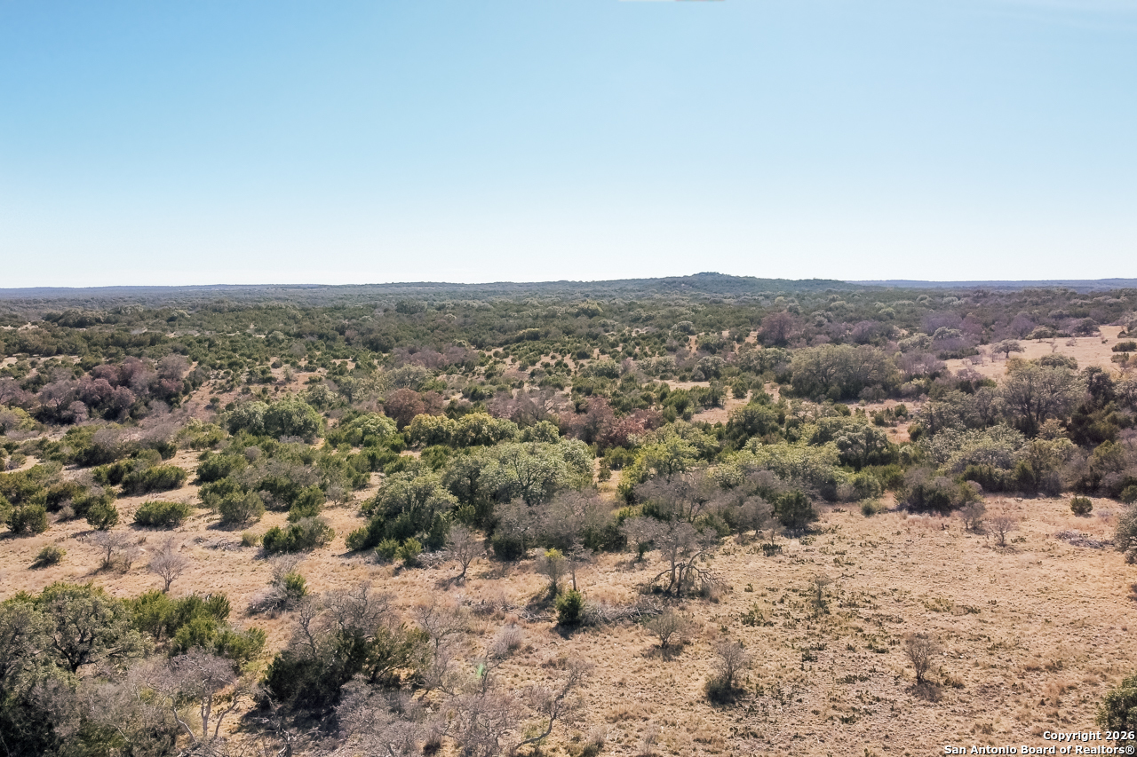 Lot 34 Spring Bluff Junction Junction, TX 76849 - Photo 4 of 16 an aerial view of house with yard and mountain view in back