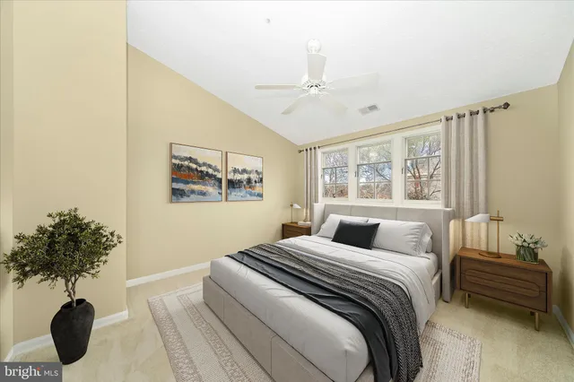 a bedroom with a bed and a potted plant