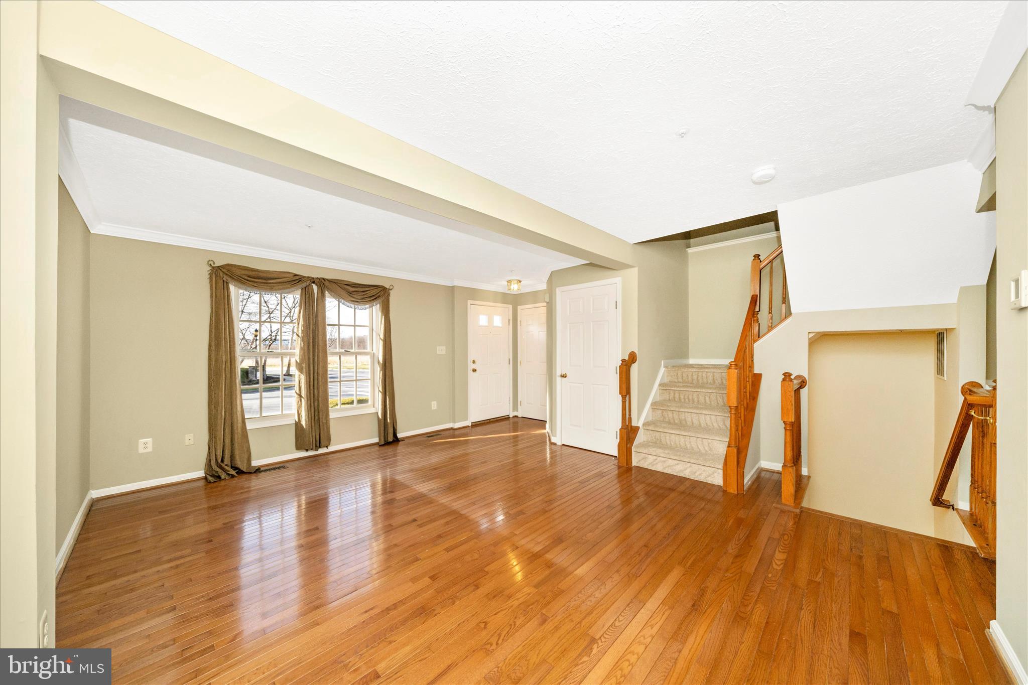 1810 Sebastian Boulevard Frederick, MD 21701 - Photo 4 of 28 a view of an empty room with wooden floor and a window