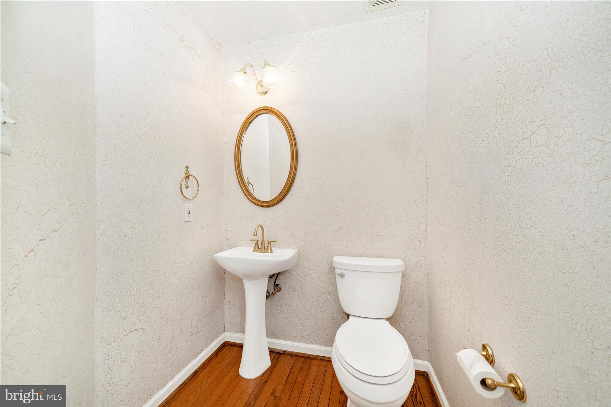1810 Sebastian Boulevard Frederick, MD 21701 - Photo 5 of 28 a bathroom with a toilet a sink and a mirror