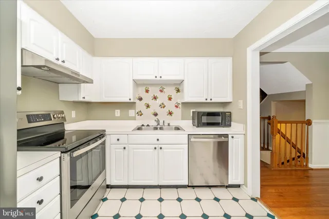 a kitchen with a stove a sink and a refrigerator