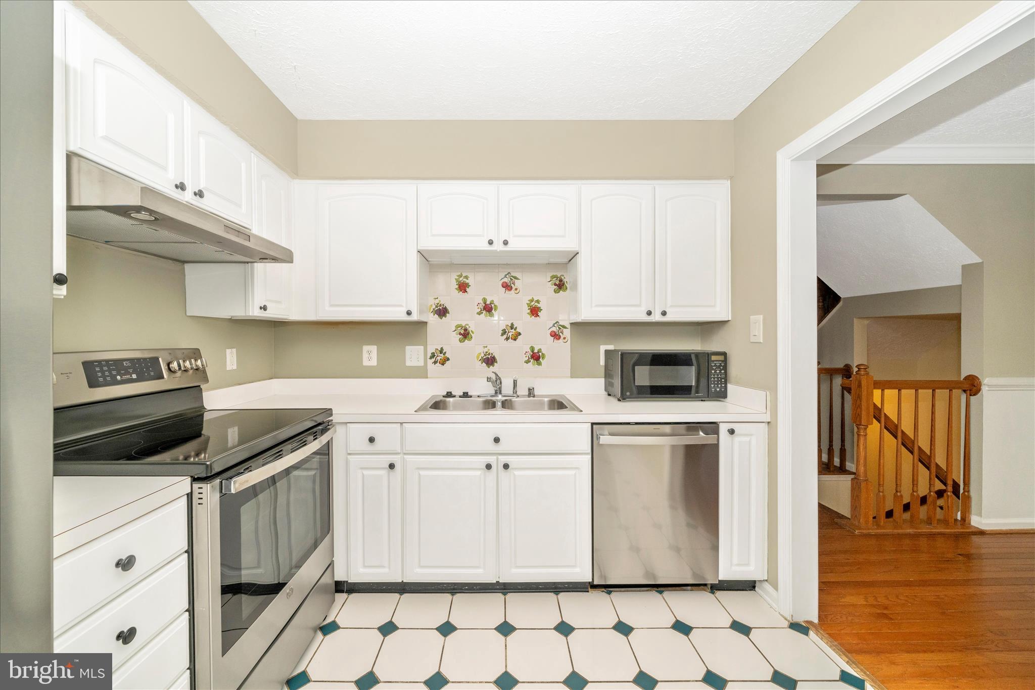 1810 Sebastian Boulevard Frederick, MD 21701 - Photo 7 of 28 a kitchen with a stove a sink and a refrigerator