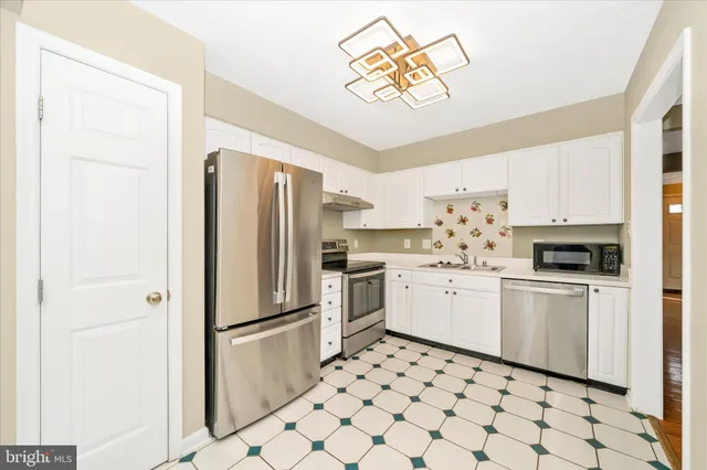 a kitchen with appliances cabinets and a sink