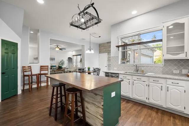 a kitchen with center island table and chairs